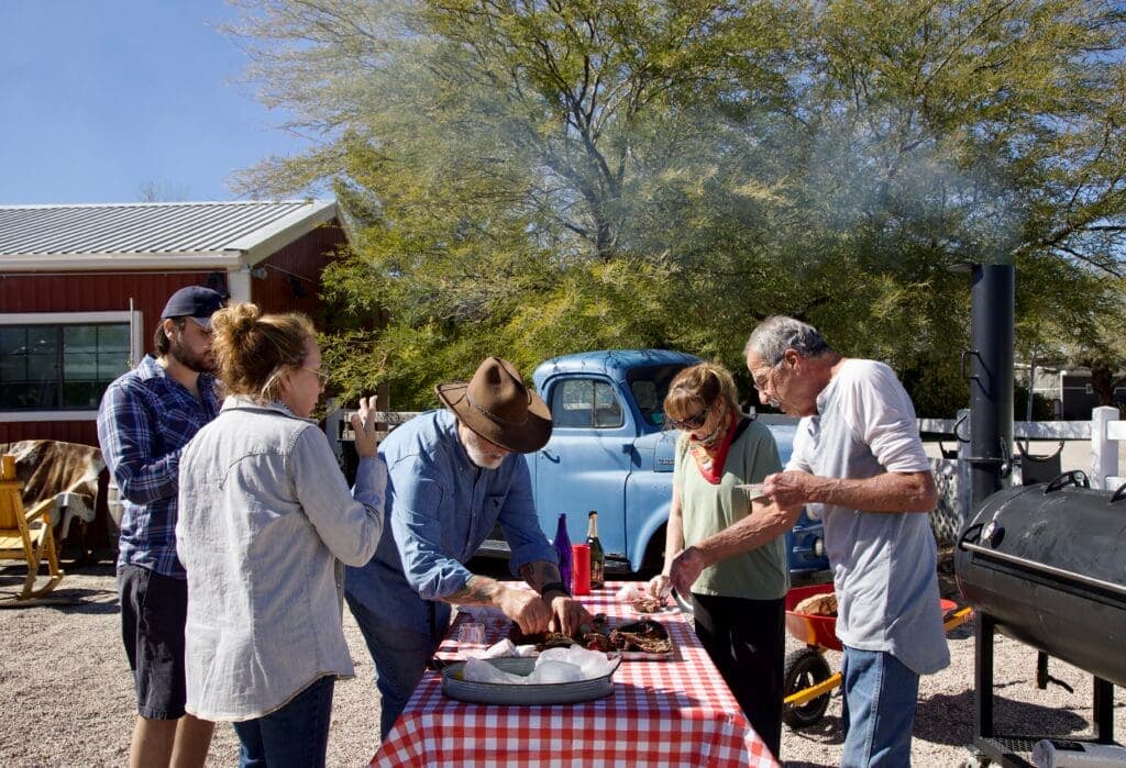 a group of people standing around a table