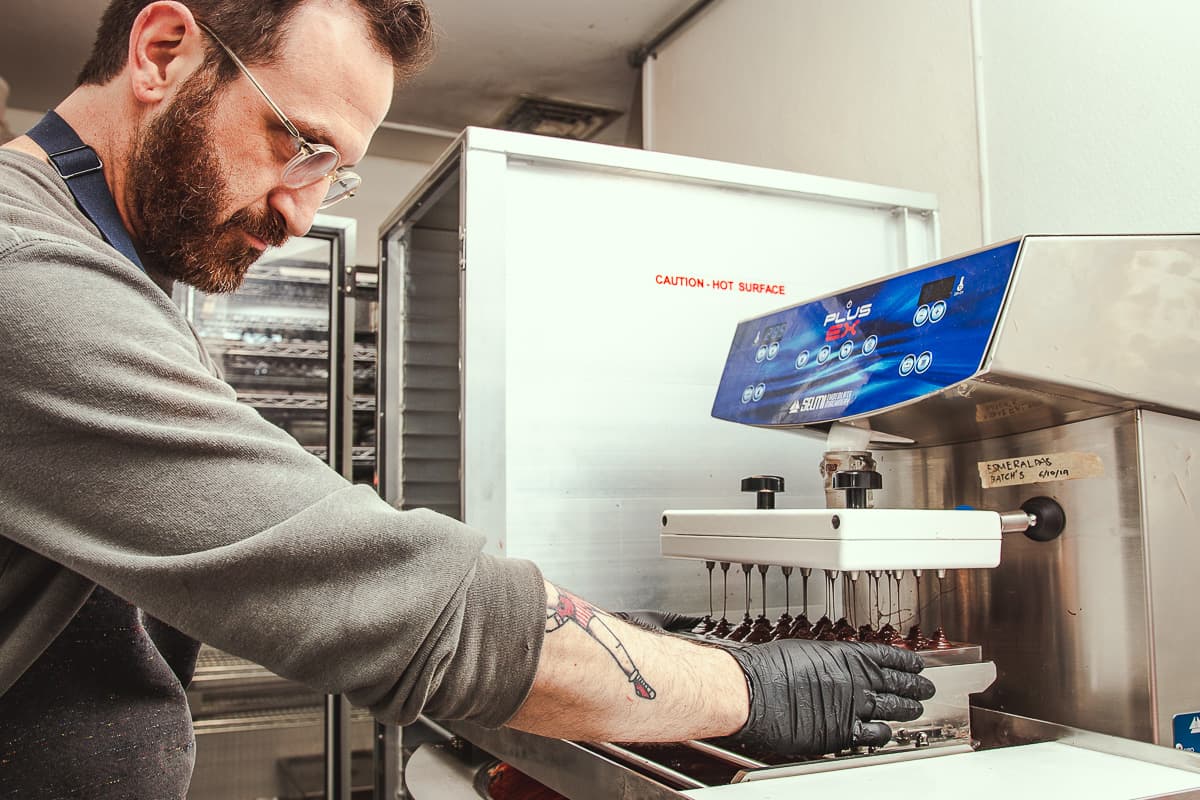 Adam Krantz making chocolate bars at Monsoon Chocolate (Credit: Jackie Tran)