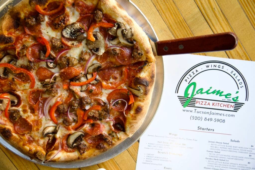 a pizza sitting on top of a wooden table