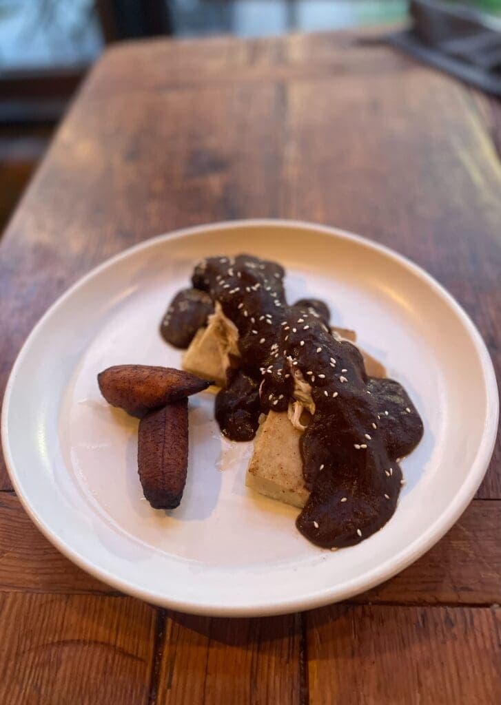 a plate of food sitting on top of a wooden table