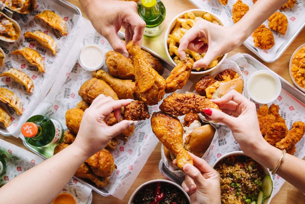 a woman holding a bunch of food on a plate