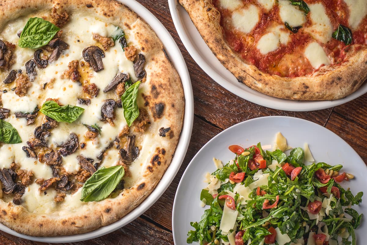 Pizza Bianca, Pizza Margherita, and Insalata Arugula from Fiamme Pizza Napoletana (Credit: Jackie Tran)
