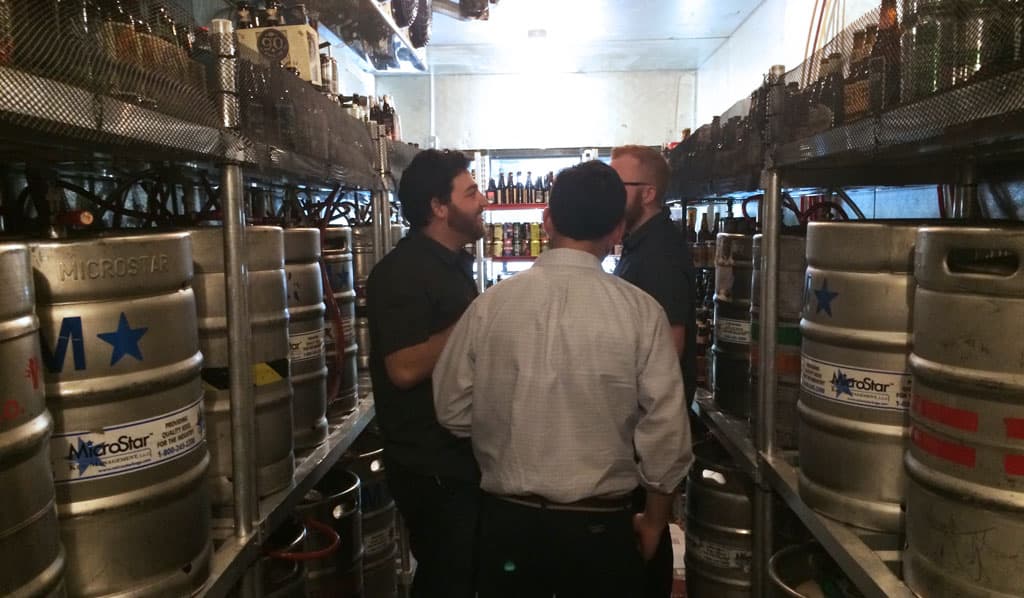 Eric Erman (left) discusses beer at Ermanos Craft Beer & Wine Bar soft opening