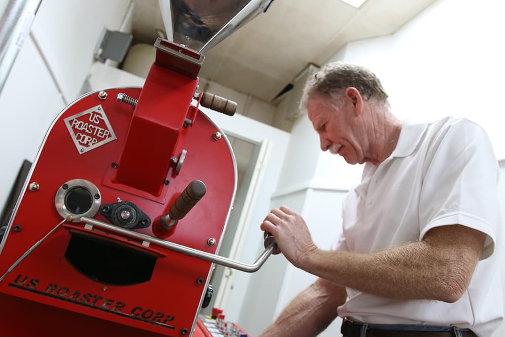 Mike Westphall roasts beans at his coffee shop, Pangean Coffee (Credit: Adam Lehrman)