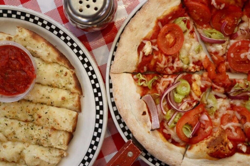a pizza sitting on top of a plate of food