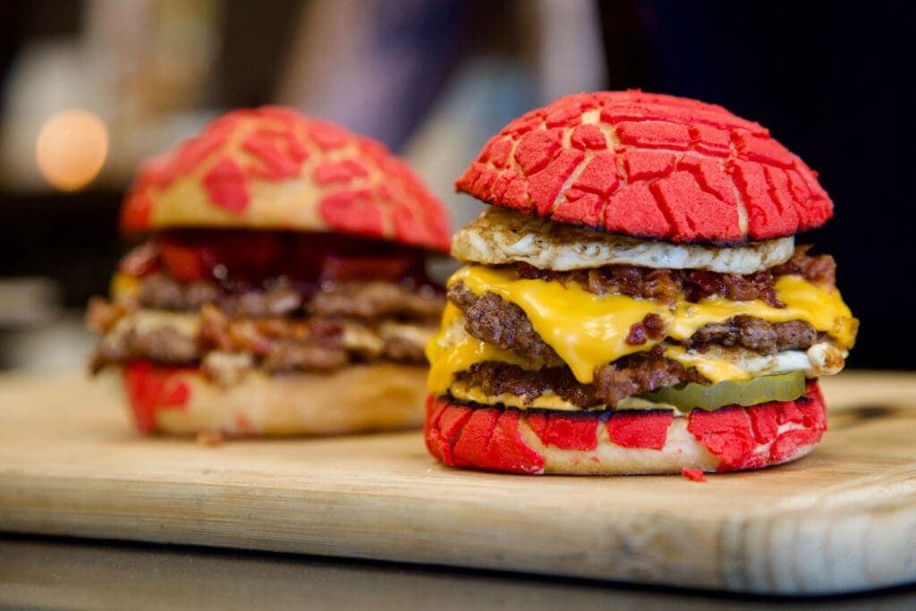a close up of a sandwich on a cutting board with a cake
