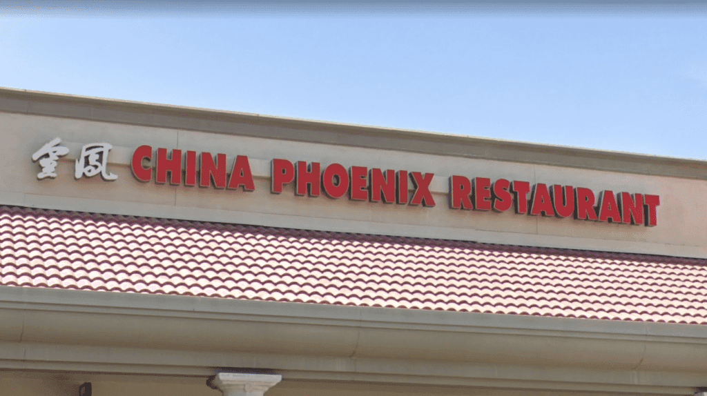 a sign in front of a building