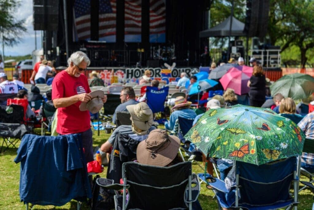 a group of people standing next to an umbrella