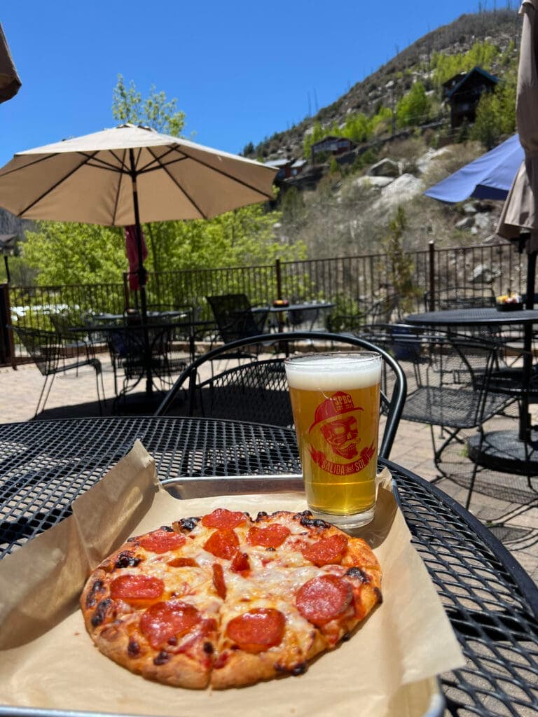 a pizza sitting on top of a picnic table
