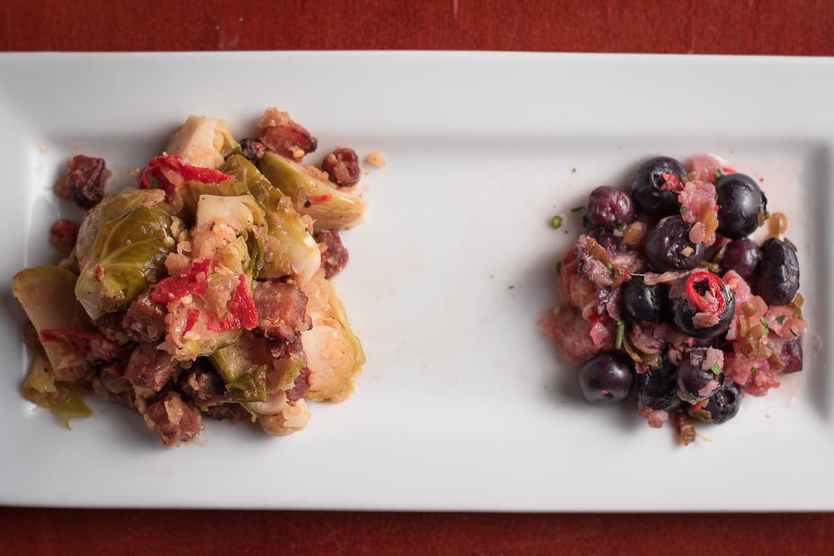 Kimchi Brussels sprouts sautéed with bacon plated alongside blueberry kimchi at the Parish (Credit: Jackie Tran)