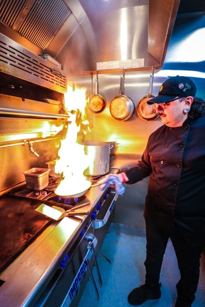 a man cooking in a kitchen preparing food