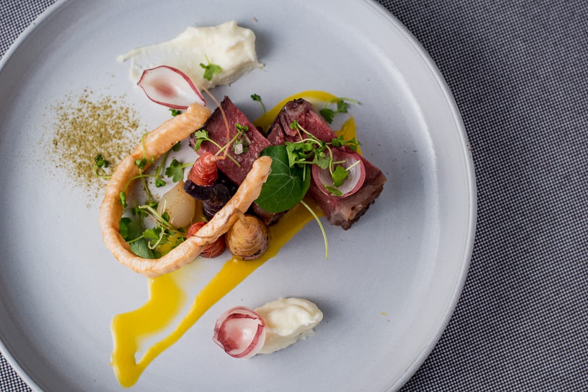 Dragoon-fermented prime strip loin, smoked egg yolk, and mirepoix at PY Steakhouse (Credit: Jackie Tran)
