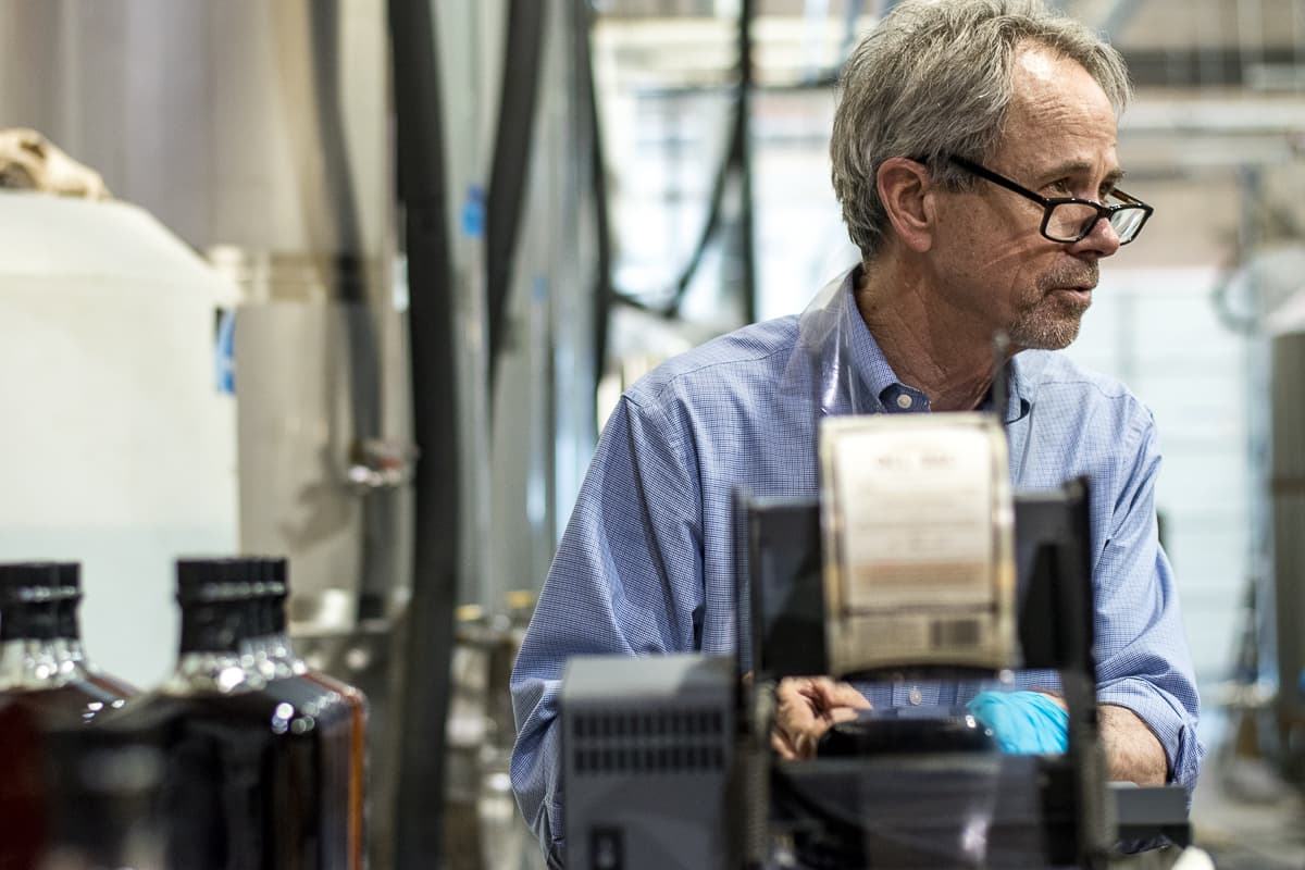 Stephen Paul, owner of Hamilton Distillers, labeling Whiskey Del Bac Distiller's Cut (Credit: Jackie Tran)