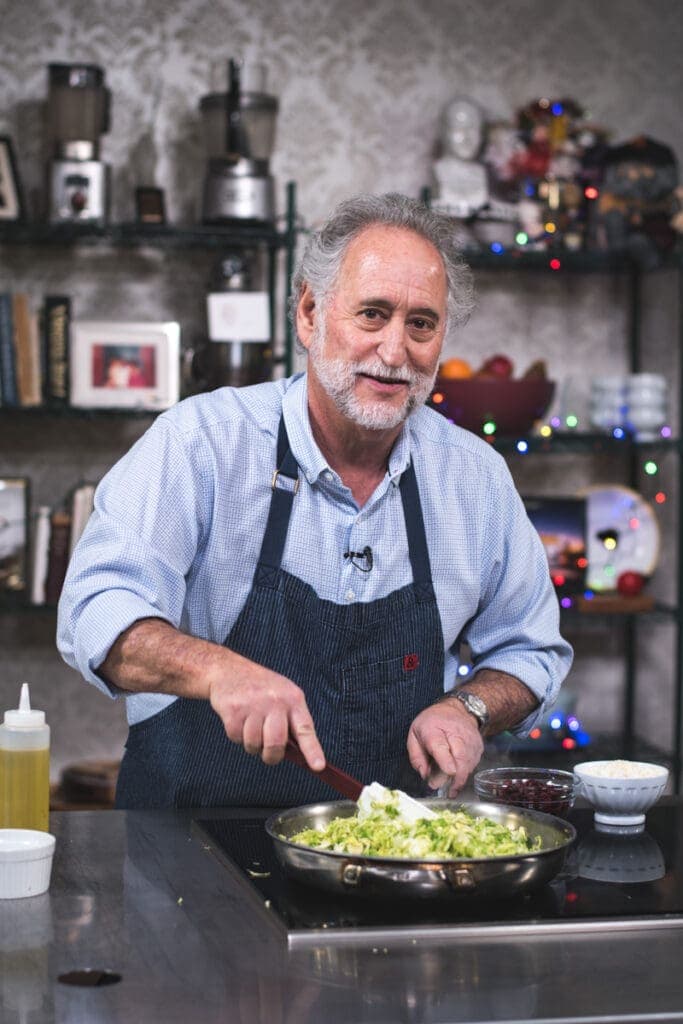 a man sitting at a table with a plate of food