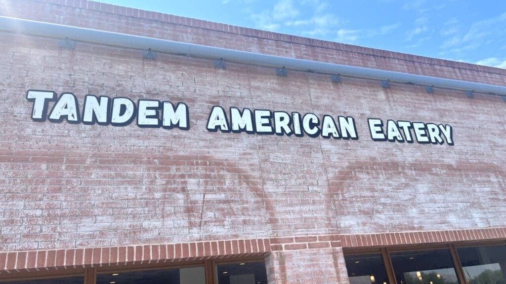 a sign in front of a brick building