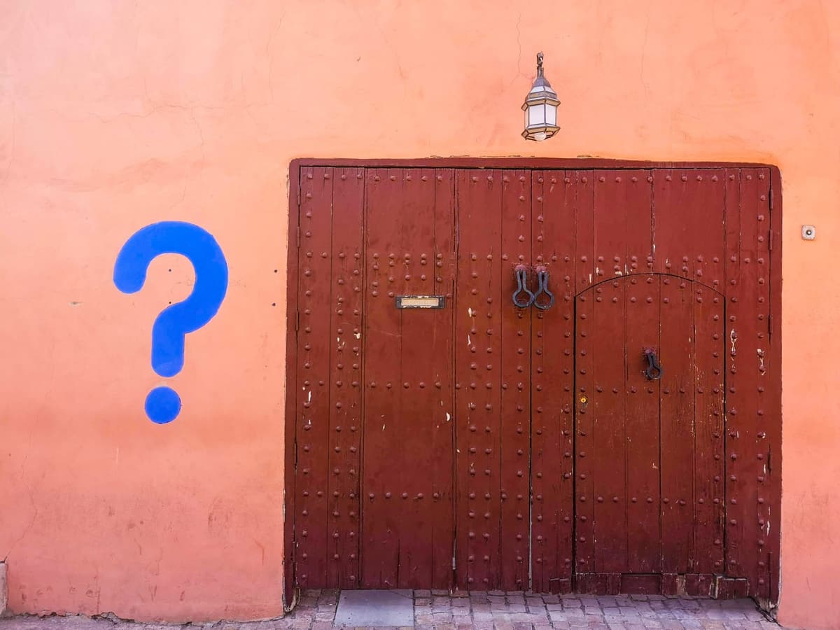 brown wooden door with blue number eight