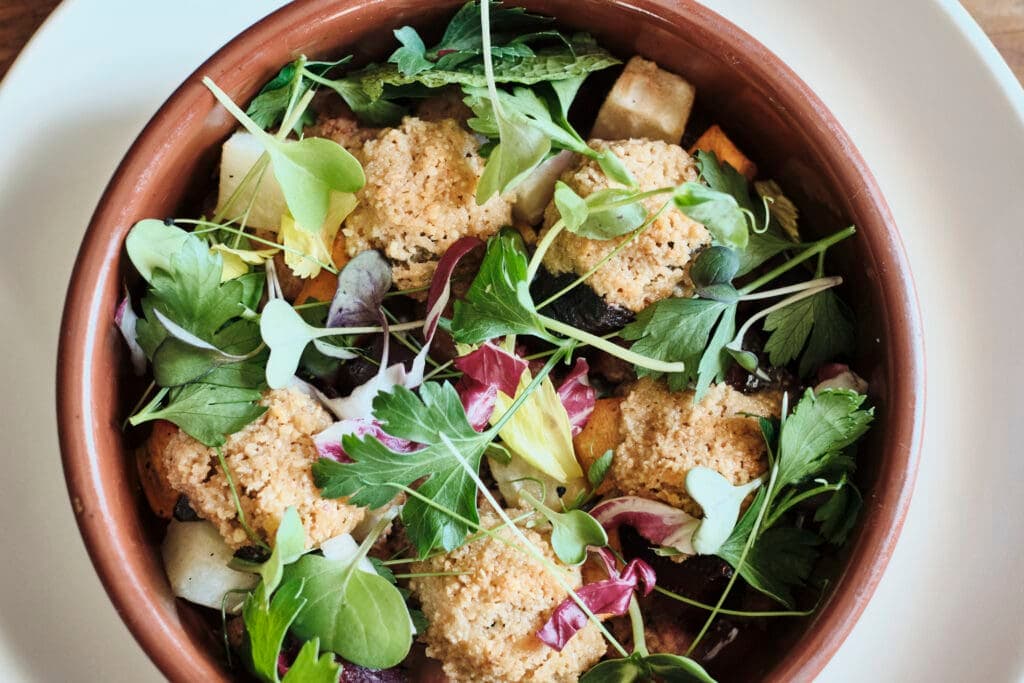 a bowl of salad on a plate