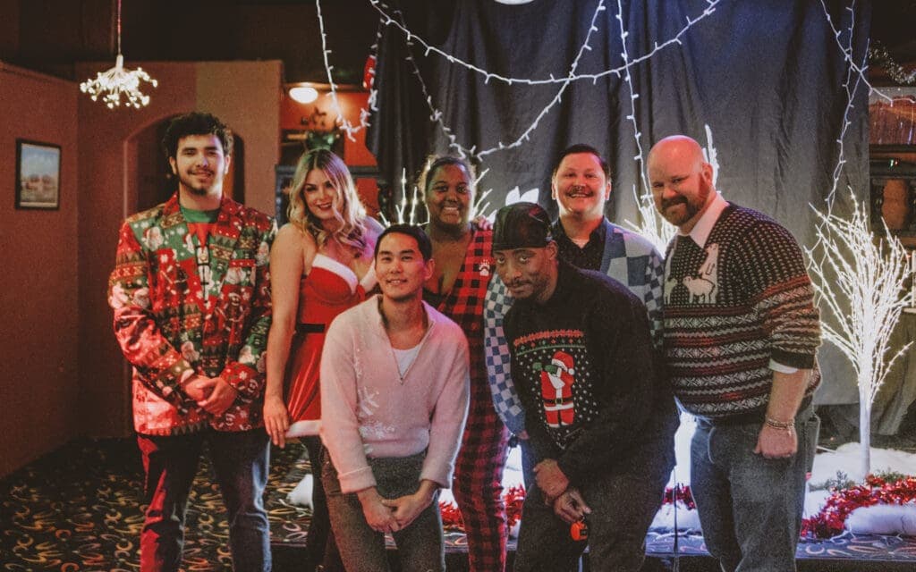 a group of people standing in front of a crowd posing for the camera