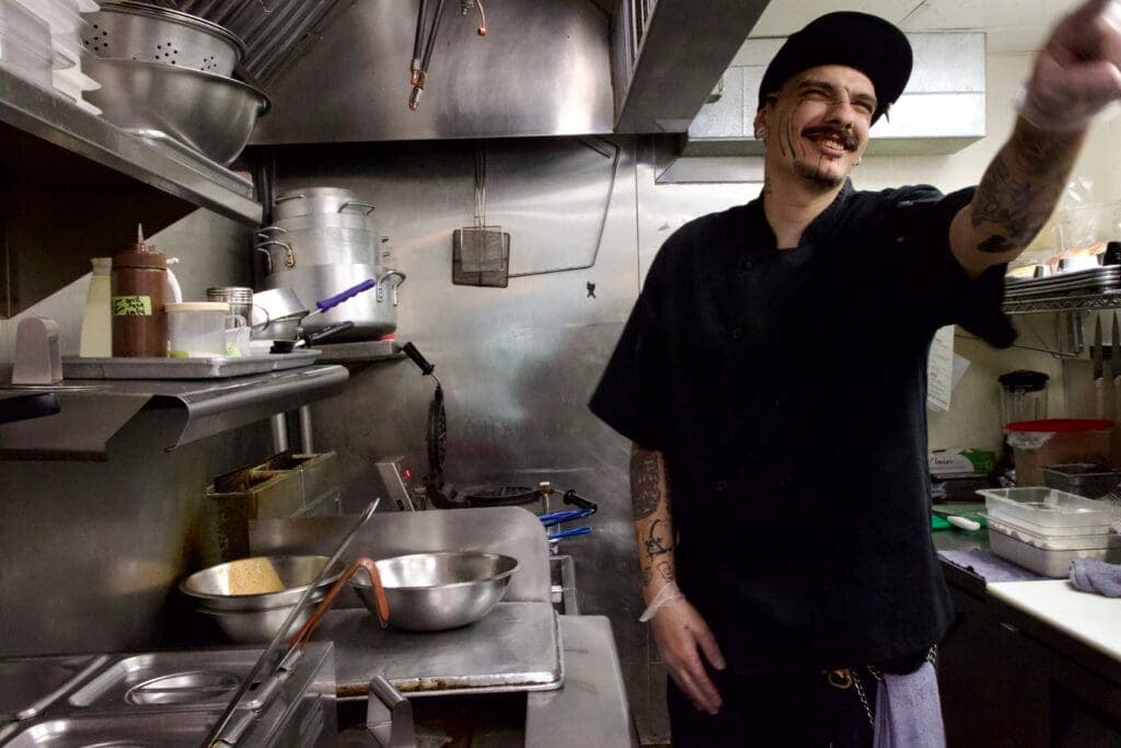 a person cooking in a kitchen preparing food