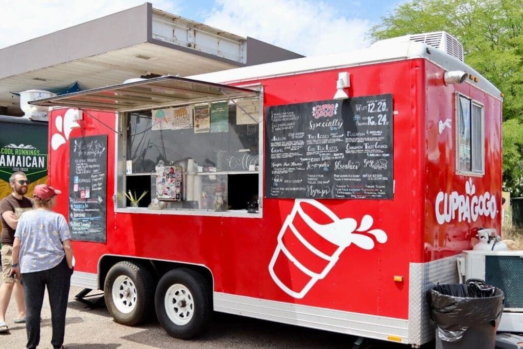 a man standing in front of a food truck