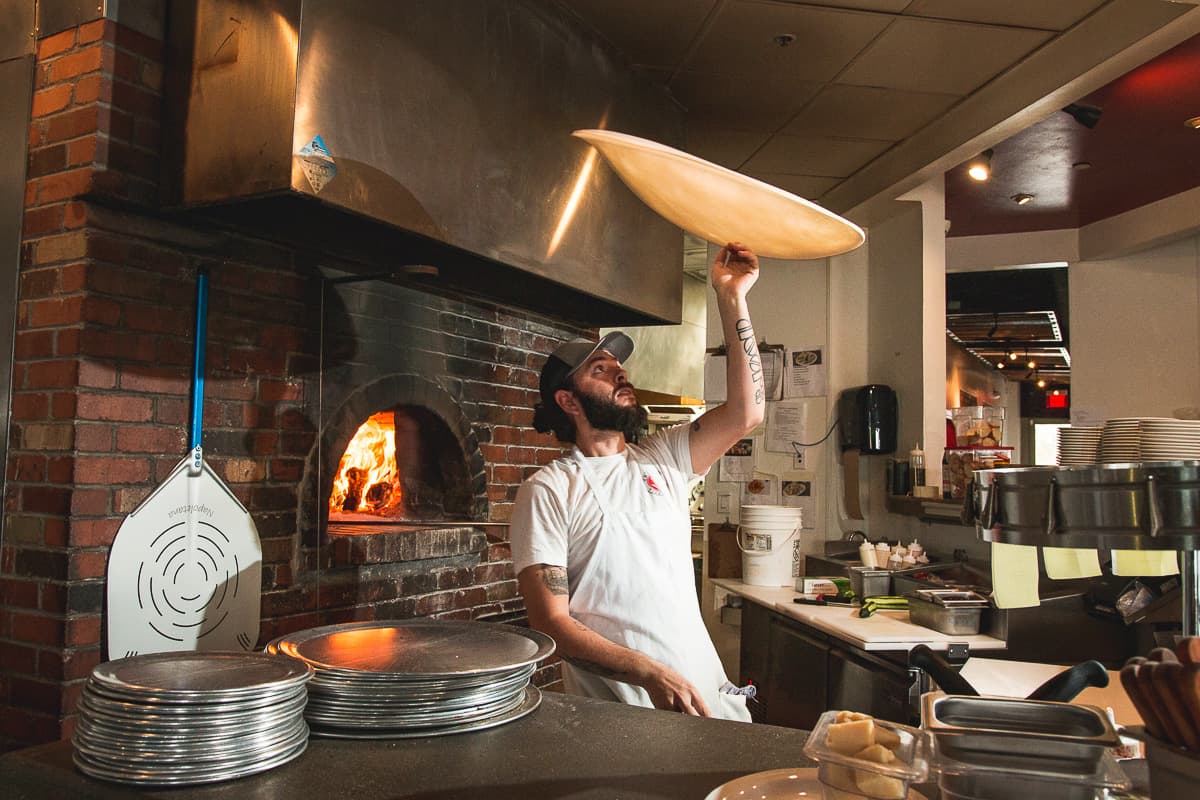 Eric Corbin tossing dough at Trident Pizza Pub (Credit: Jackie Tran)