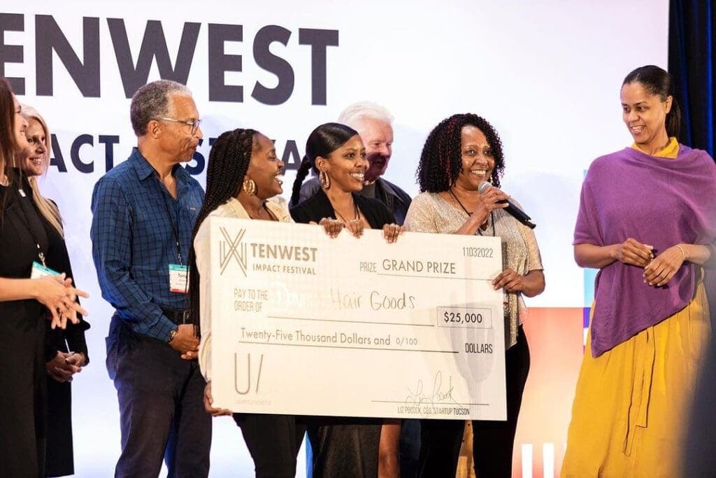 a group of people standing next to a person holding a sign