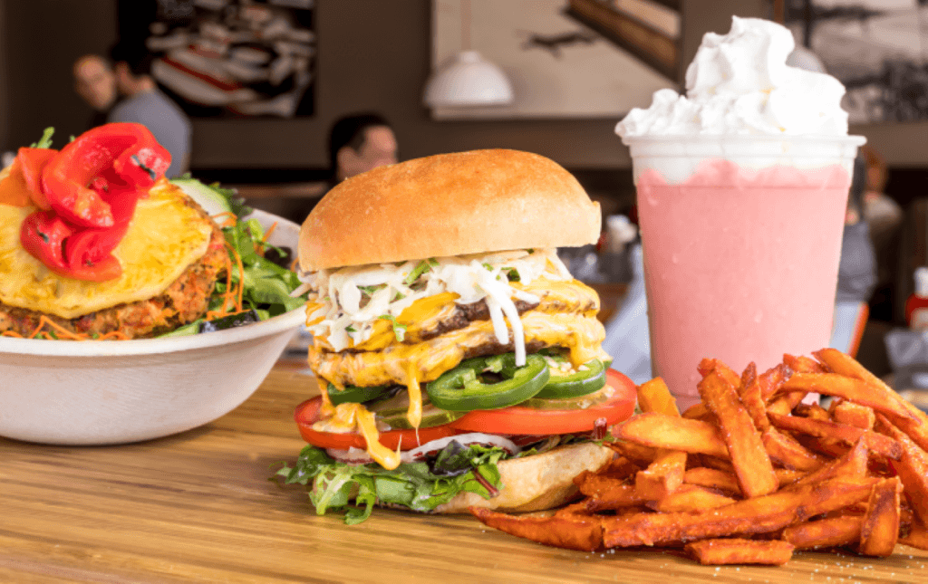 a close up of a sandwich and fries on a plate