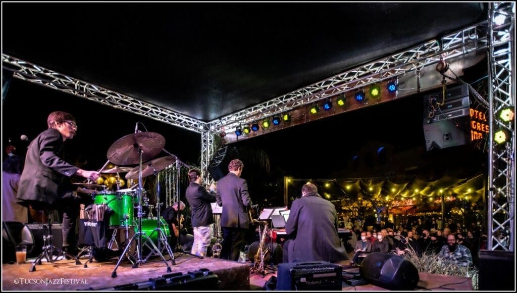 a group of people standing on a stage in front of a crowd