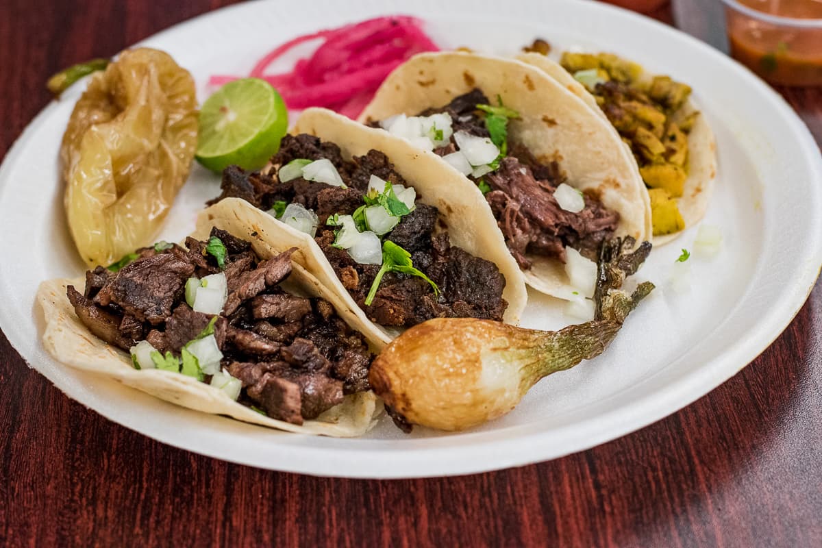 Tacos de carne asada, chicharron de puerco, cabeza, and pollo asado at Carniceria Los Vaqueros