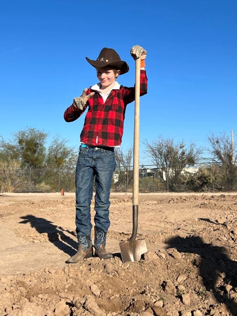 a man standing on top of a dirt field