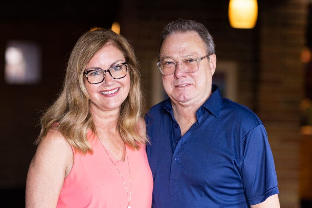 a man and a woman smiling for the camera