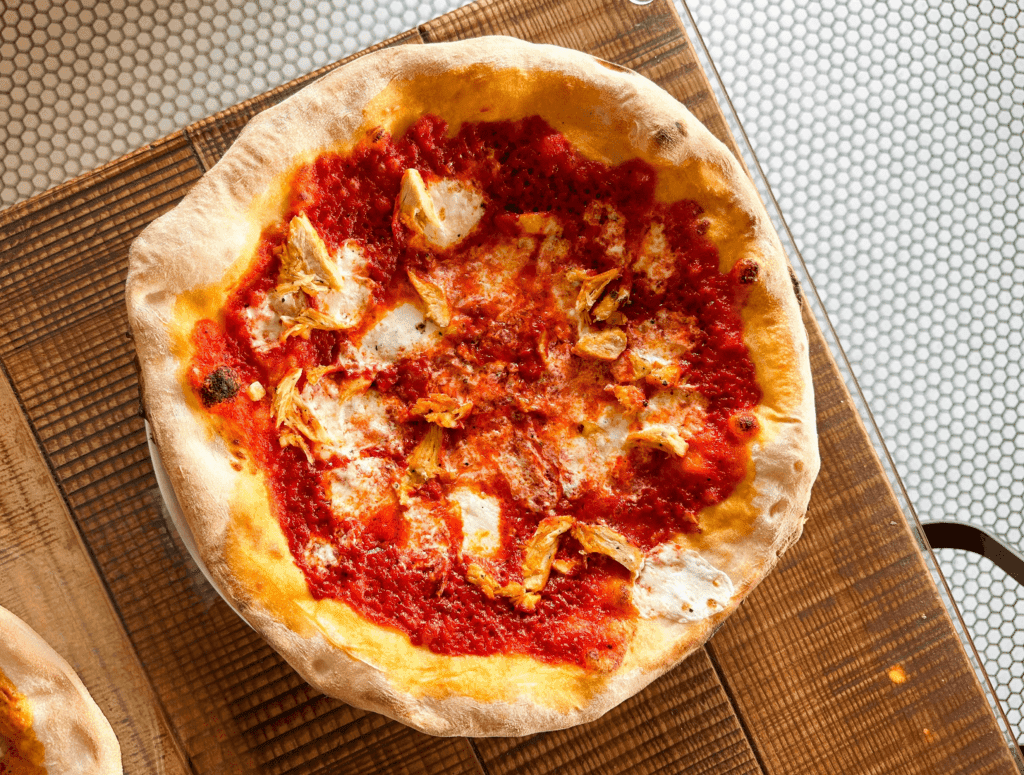 a pizza sitting on top of a wooden table