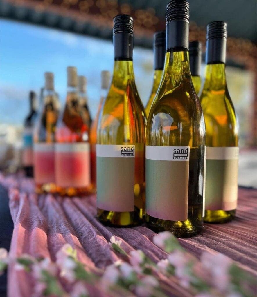 a close up of a bottle and a glass of wine