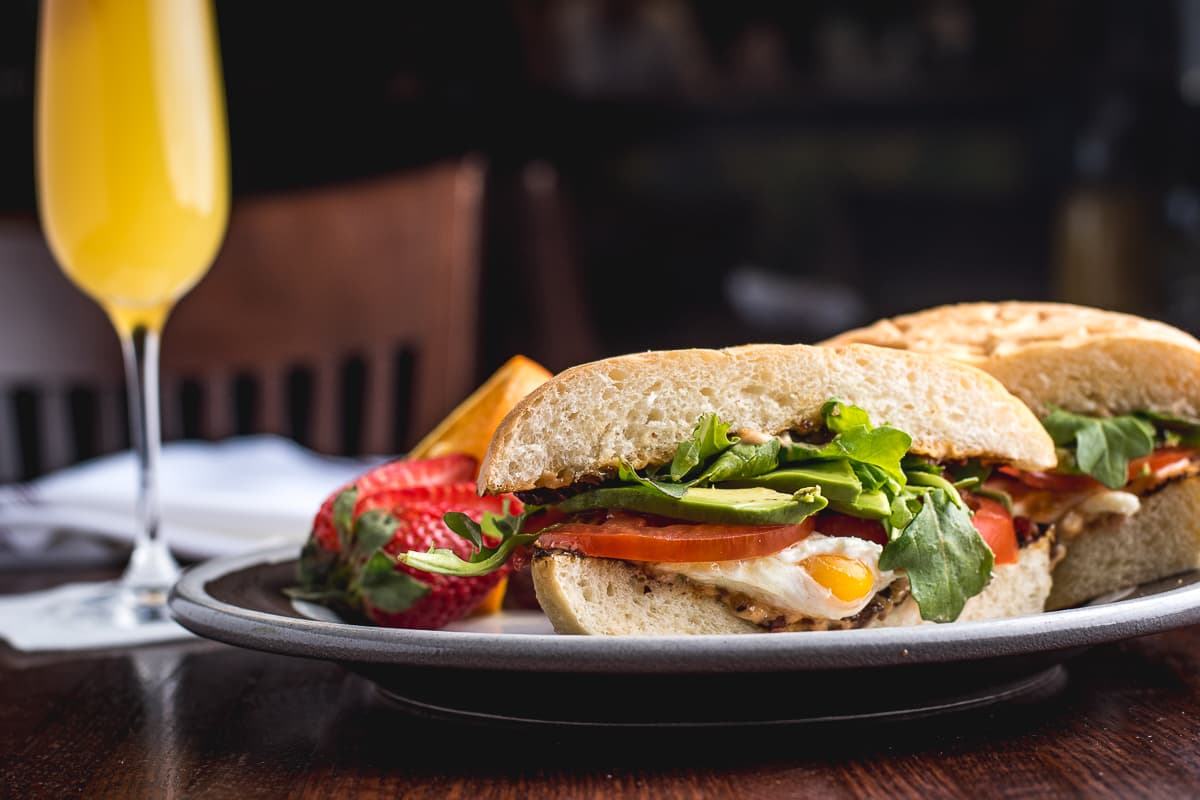 Belt Sandwich with a side of fruit and a Mimosa at Zona 78 (Credit: Jackie Tran)