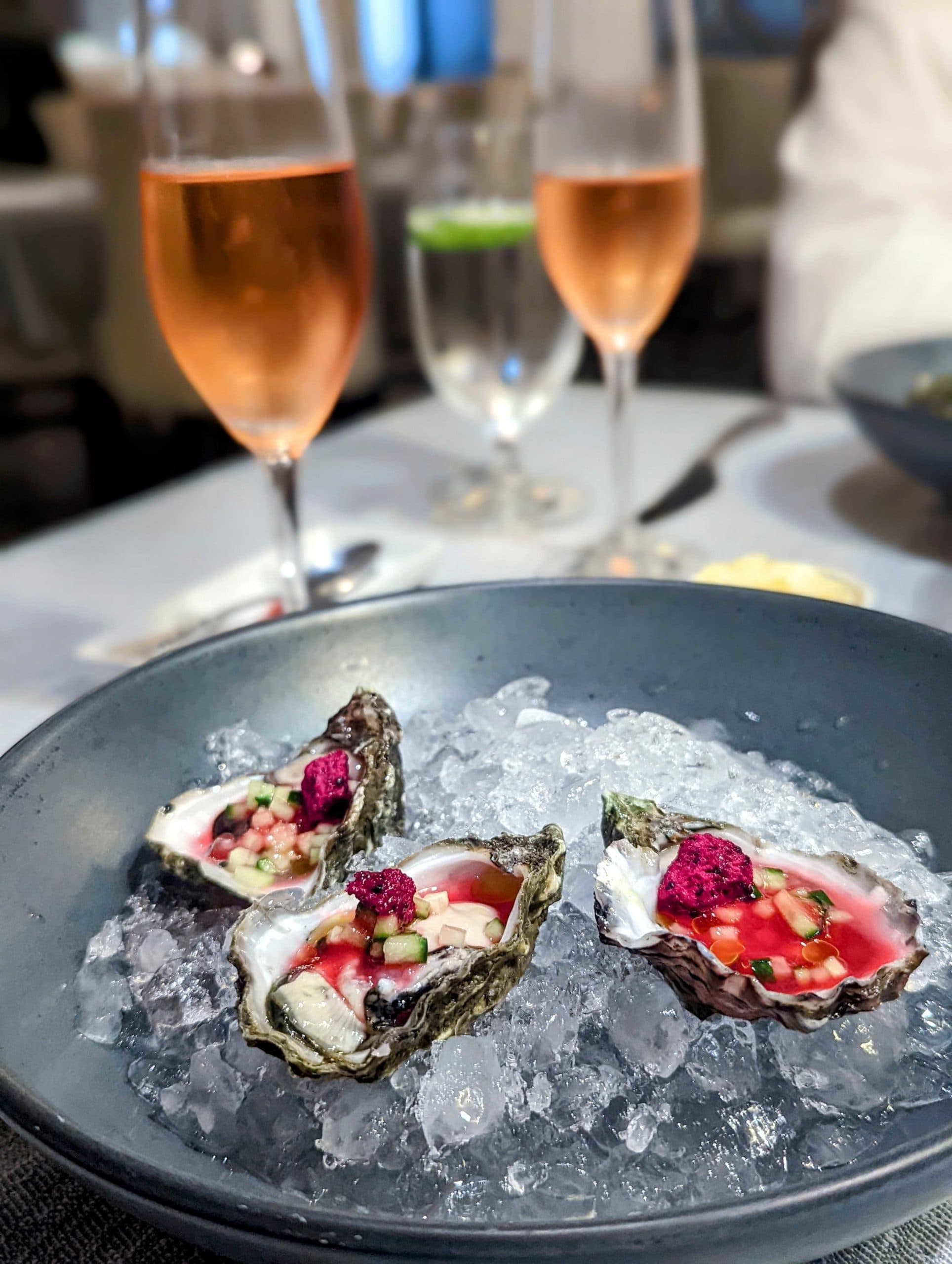 Kumomoto Oysters with Prickly Pear Vinegar, Freeze-Dried Prickly Pear, Cucumber, and Mint Oil