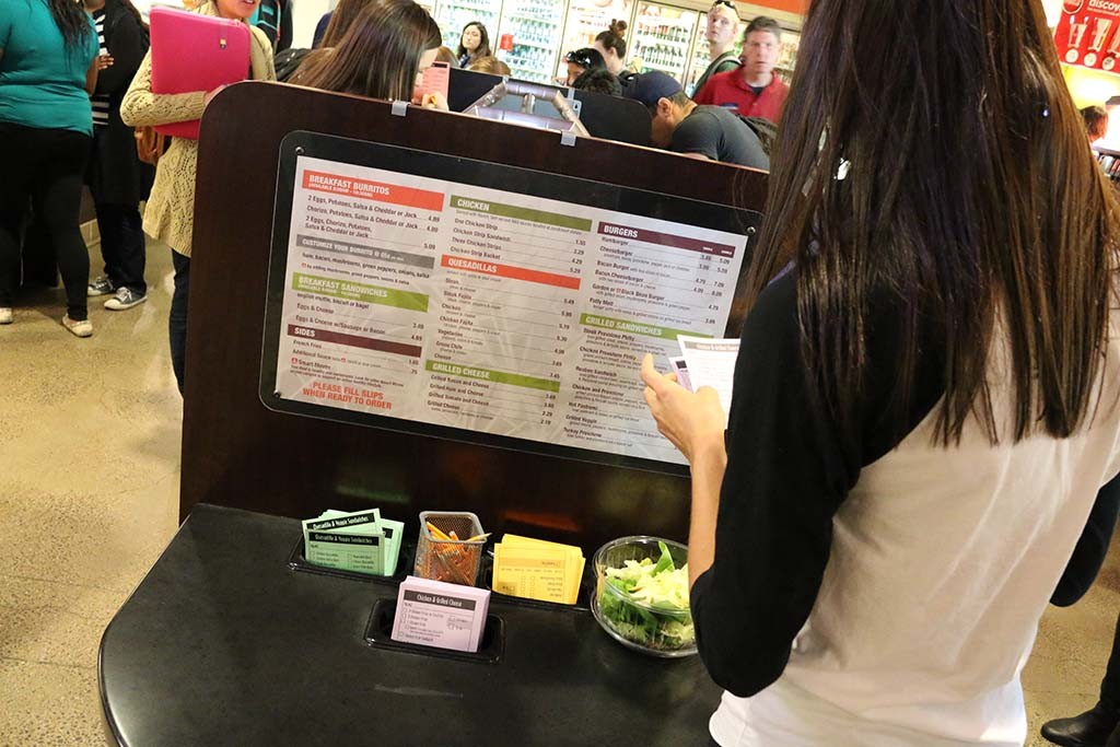 A student selects from a number of options at Cactus Grill