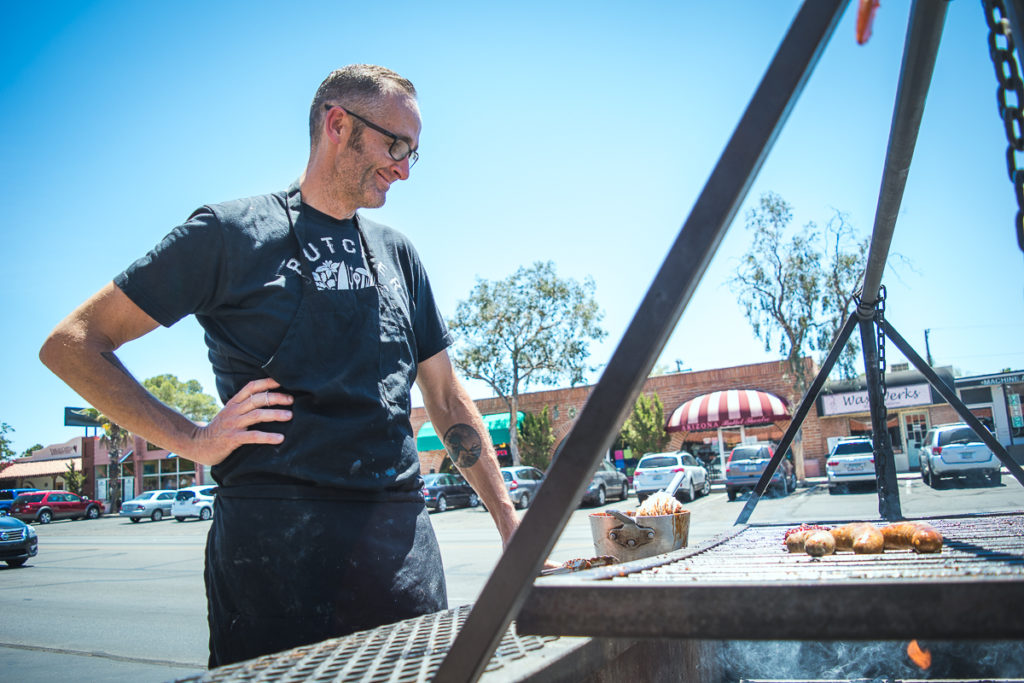 Ben Forbes of Forbes Meat Company grilling sausages at Rincon Market (Credit: Jackie Tran)