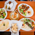 Mediterranean Salad, Chicken Shawarma, assorted sweets, Falafel Plate, hummus, pita, and Kafta Kebab Plate at Caravan Grill (Credit: Jackie Tran)