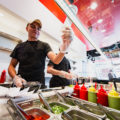 An employee at poke restaurant, Hoki Poki, checks an order (Credit: Adam Lehrman)
