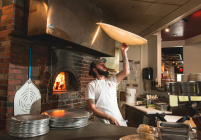 Eric Corbin tossing dough at Trident Pizza Pub (Credit: Jackie Tran)