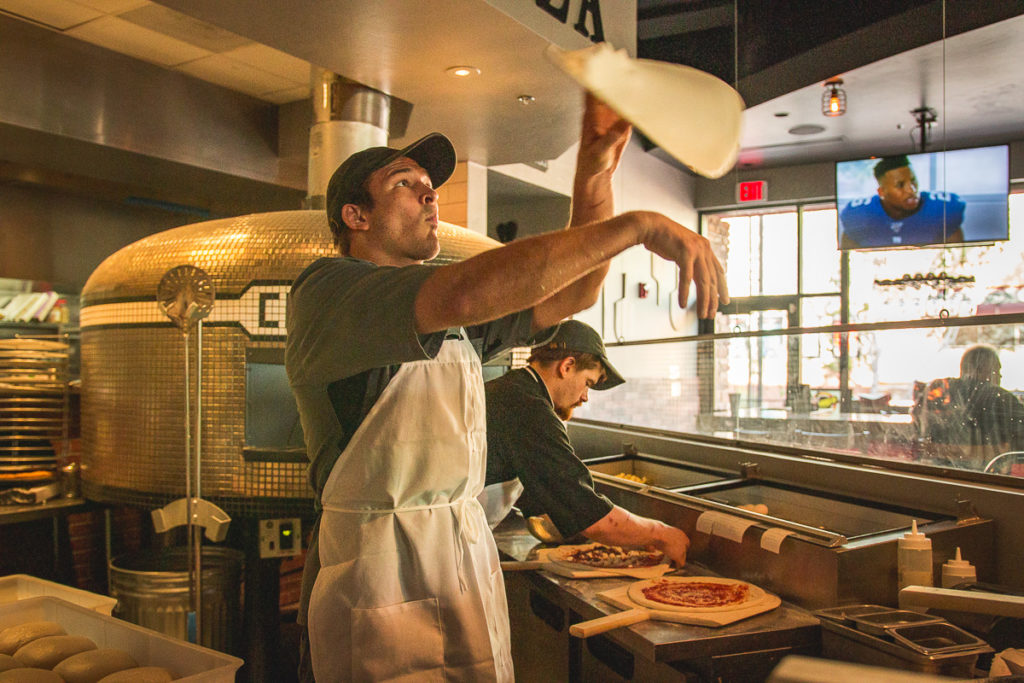 Chef Luke Smith tossing pizza at Charred Pie