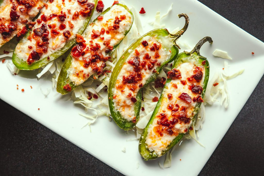 a picture of cheesy, gooey jalapenos