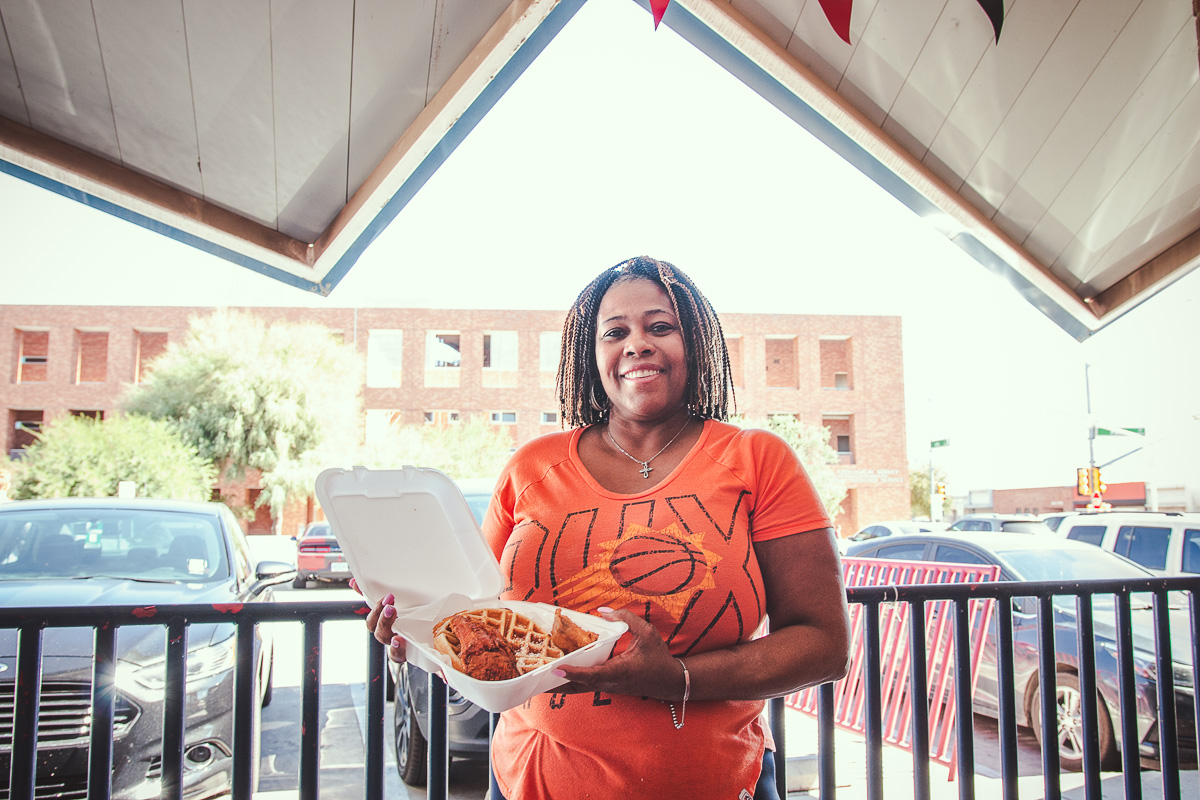 Tisha Carey with chicken and waffles at Mama Carey's Kitchen