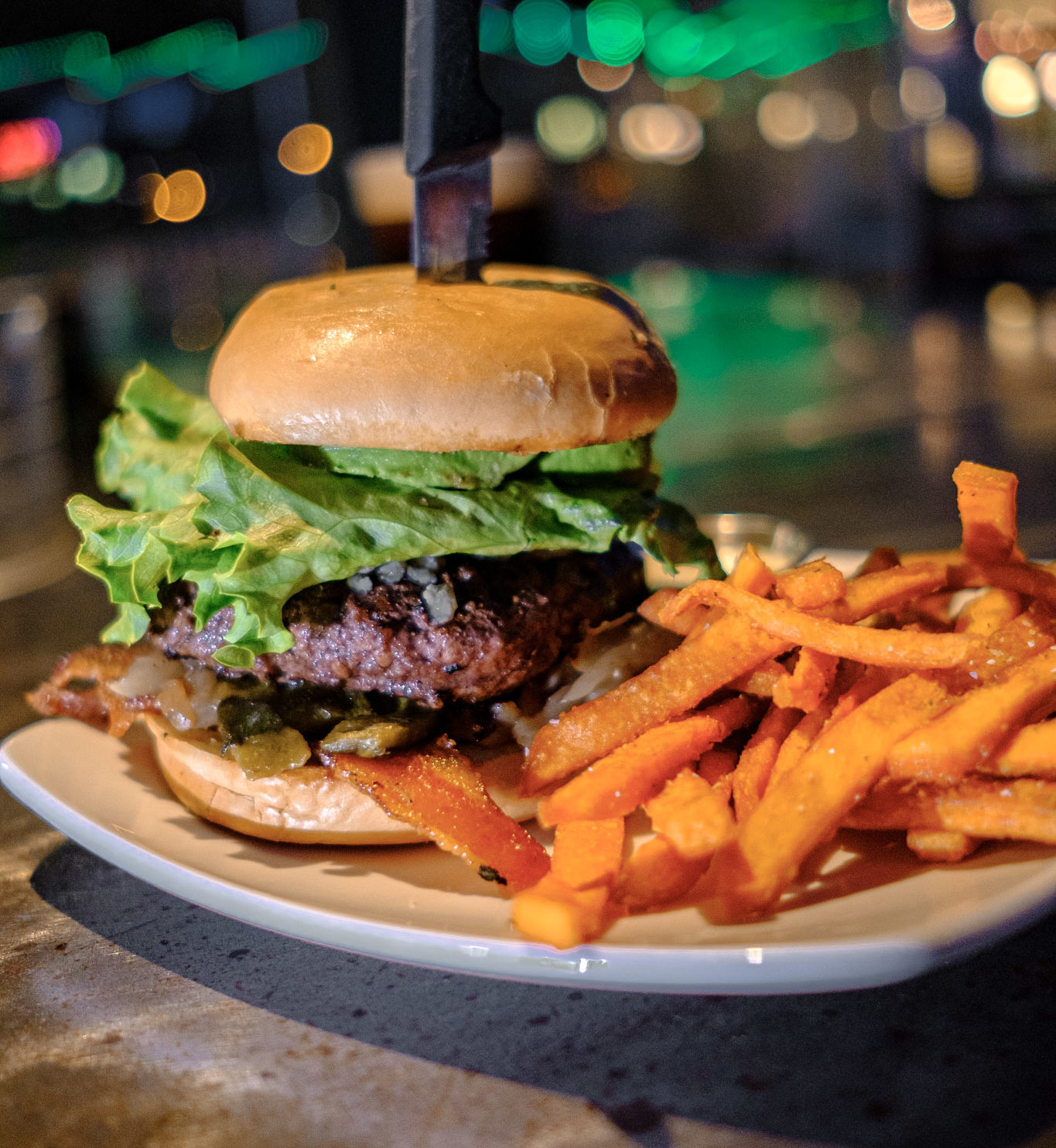 a picture of a burger and sweet potato fries on a plate
