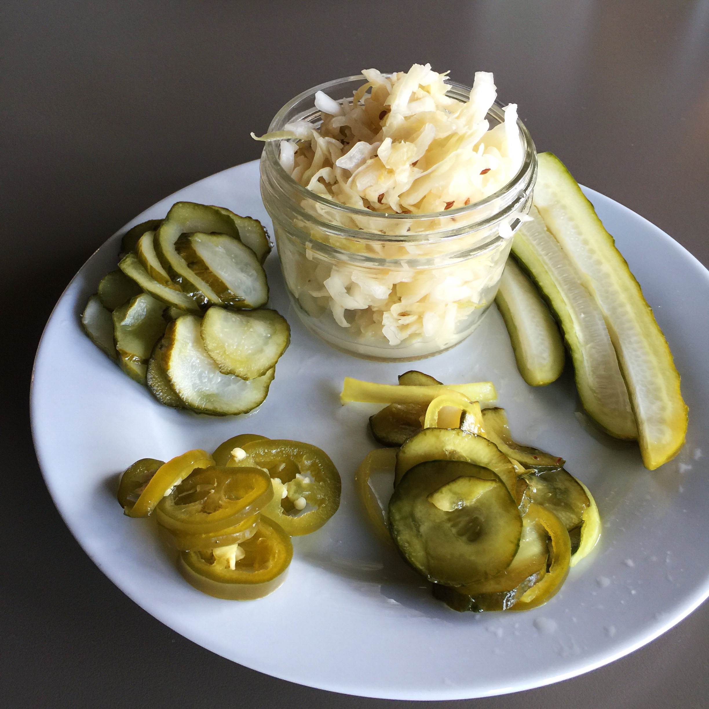 Dill pickle chips, sauerkraut, dill spears, bread & butter pickles, and pickled jalapeños at Stray Dogs (Credit: Stray Dogs)