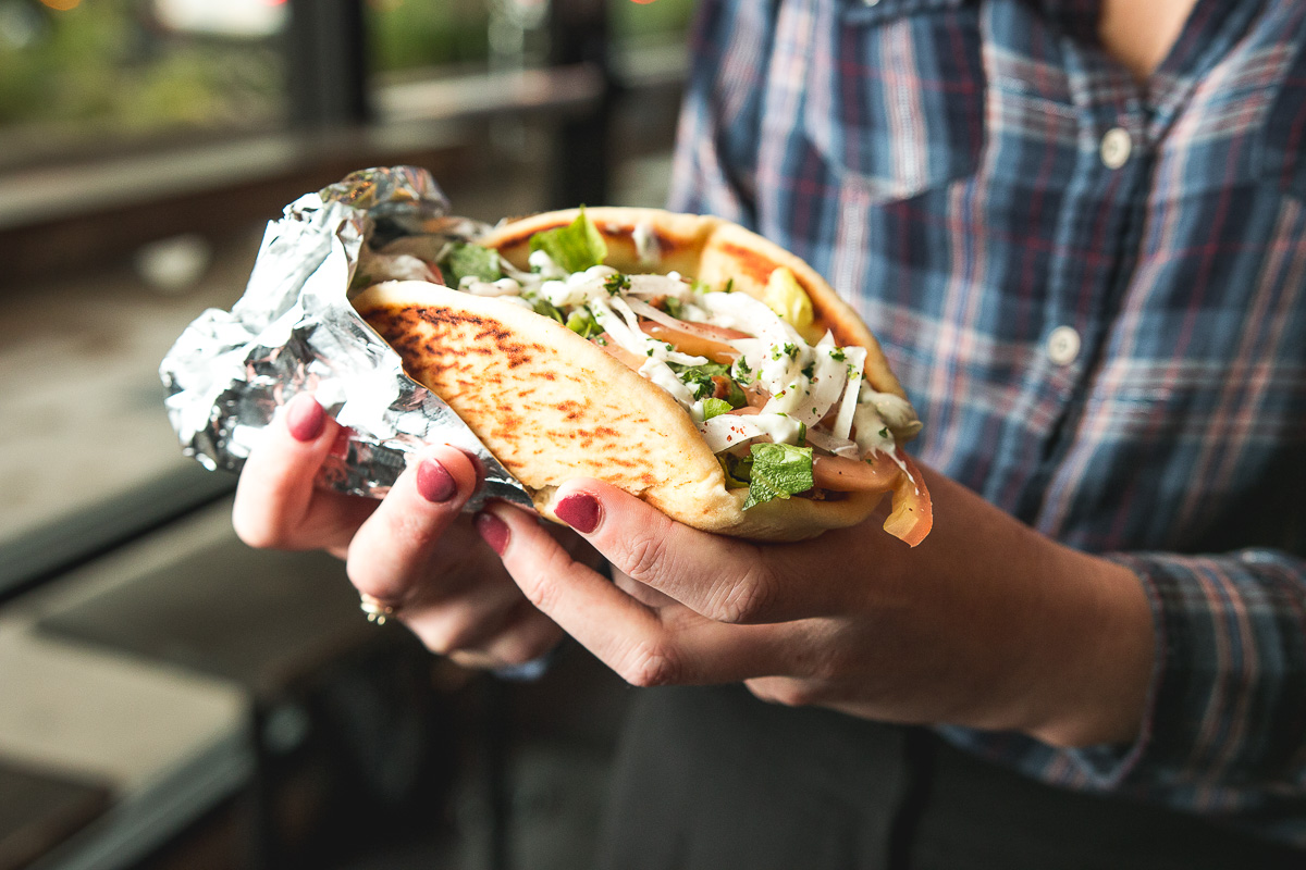 a person holding a gyro