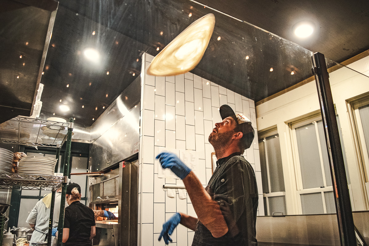 Jason Purdy tossing pizza at Proof Artisanal Pizza & Pasta (Credit: Jackie Tran)