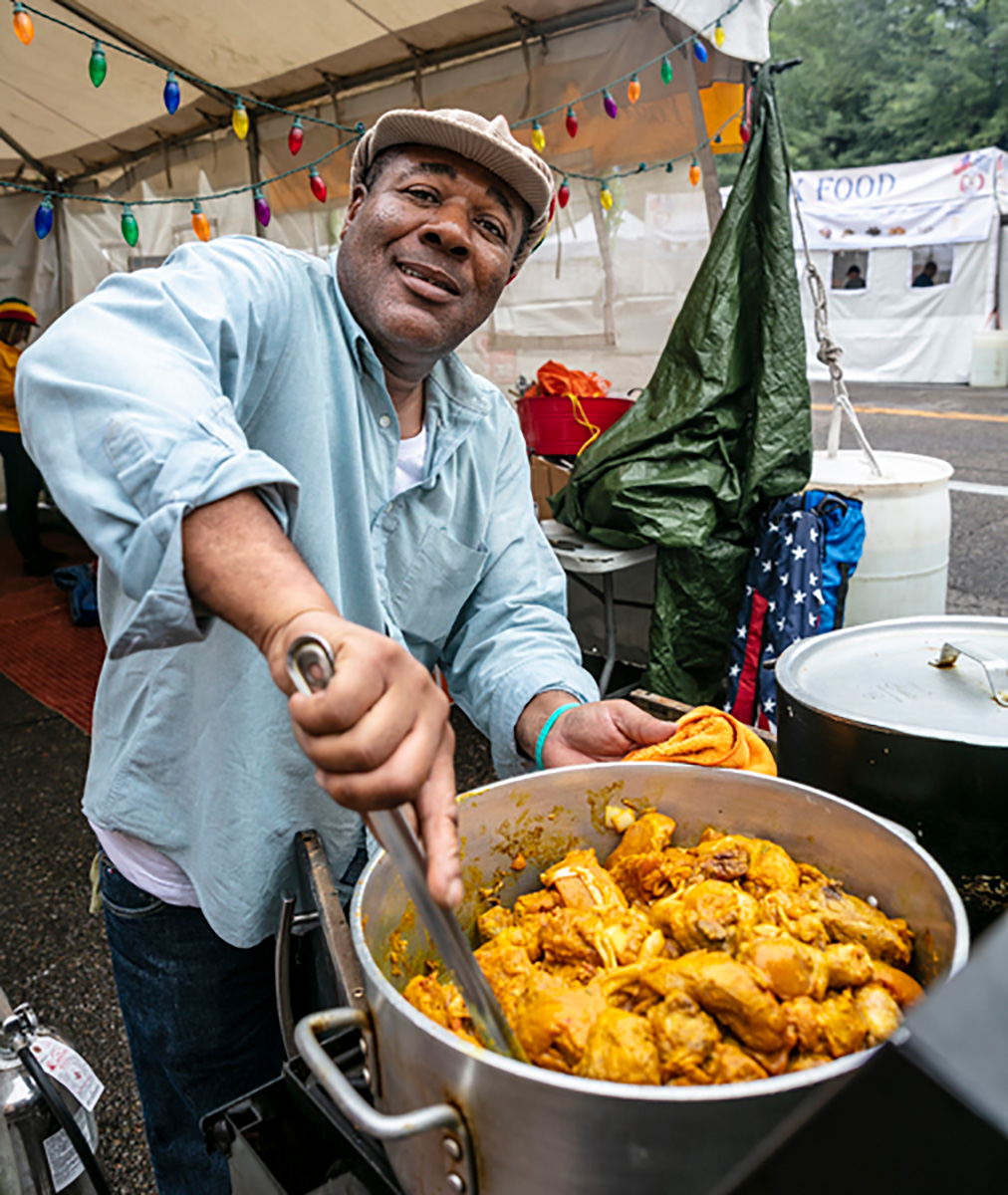 Patrick Powell of CeeDee Jamaican Kitchen stirs up some curry chicken at Tucson Meet Yourself