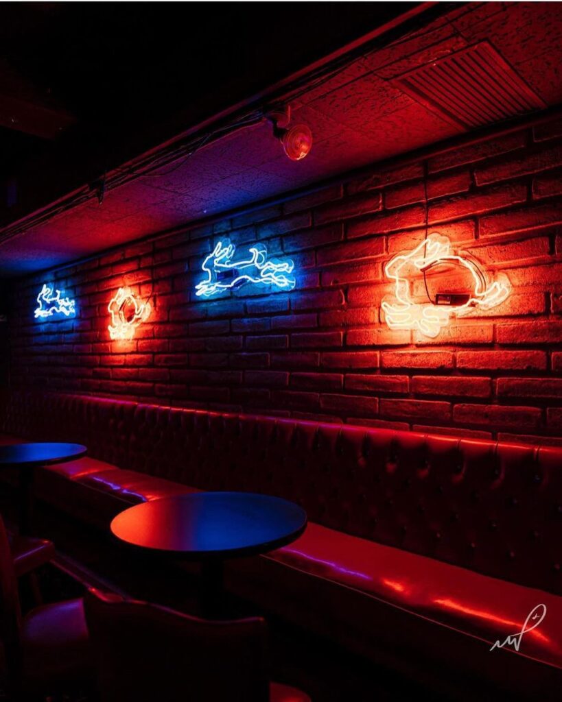 A photo of the seating area and brick wall backdrop within Jackrabbit Lounge in Tucson