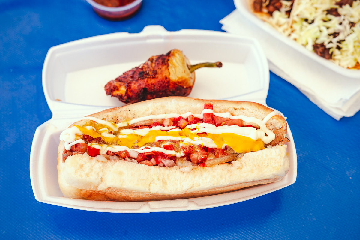 a plate of hot dogs with different toppings sitting on a table